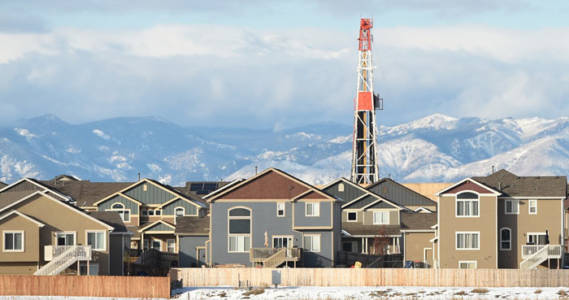 image of a fracking well beside a neighborhood